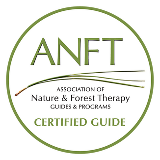ANFT Certified Guide Round badge that says "ANFT CERTIFIED GUIDE - Association of Nature & Forest Therapy Guides & Programs"