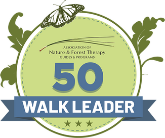 Round badge that says "50 WALK LEADER - Association of Nature & Forest Therapy Guides & Programs"