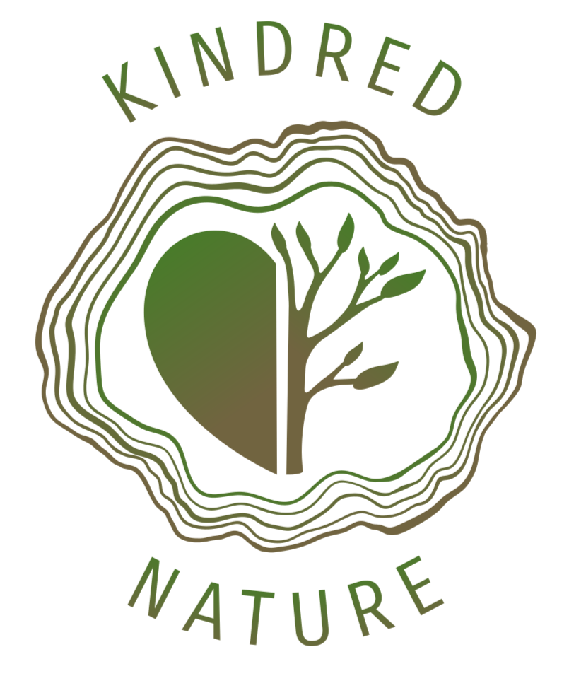 Kindred Nature Logo A logo with half of a heart and half of a tree silhouette within tree rings, and the words Kindred Nature curved around the top and bottom, with a gradient of green and brown colors.