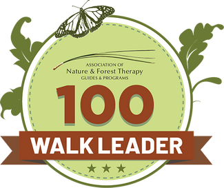 100 Walk Leader Round badge that says "100 WALK LEADER - Association of Nature & Forest Therapy Guides & Programs"